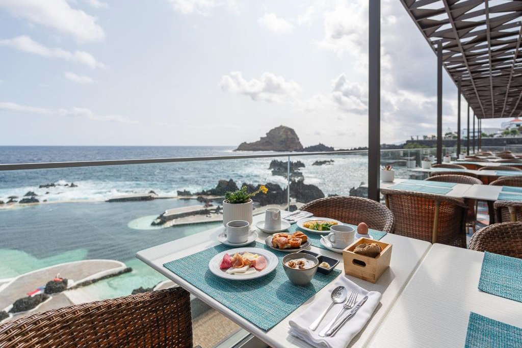 Where to stay in Madeira - Aqua Natura Madeira View from Aqua Natura Madeira restaurant overlooking the Atlantic Ocean and natural lava pools in Porto Moniz, Madeira.